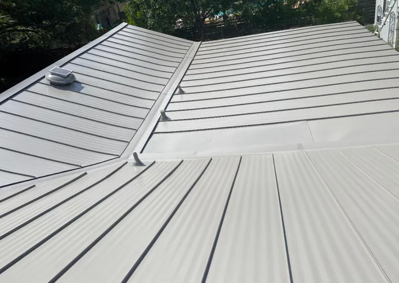 Solar attic fan installed on a metal roof for Roof Ventilation in Crockett